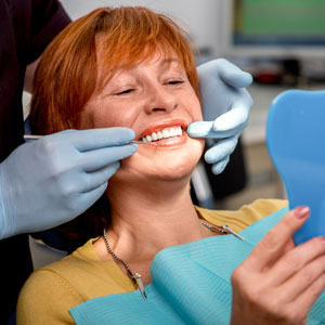 woman-being-fitted-with-dentures-sq-300