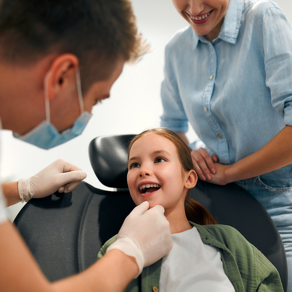 Pediatric dentist examining a young child?s teeth