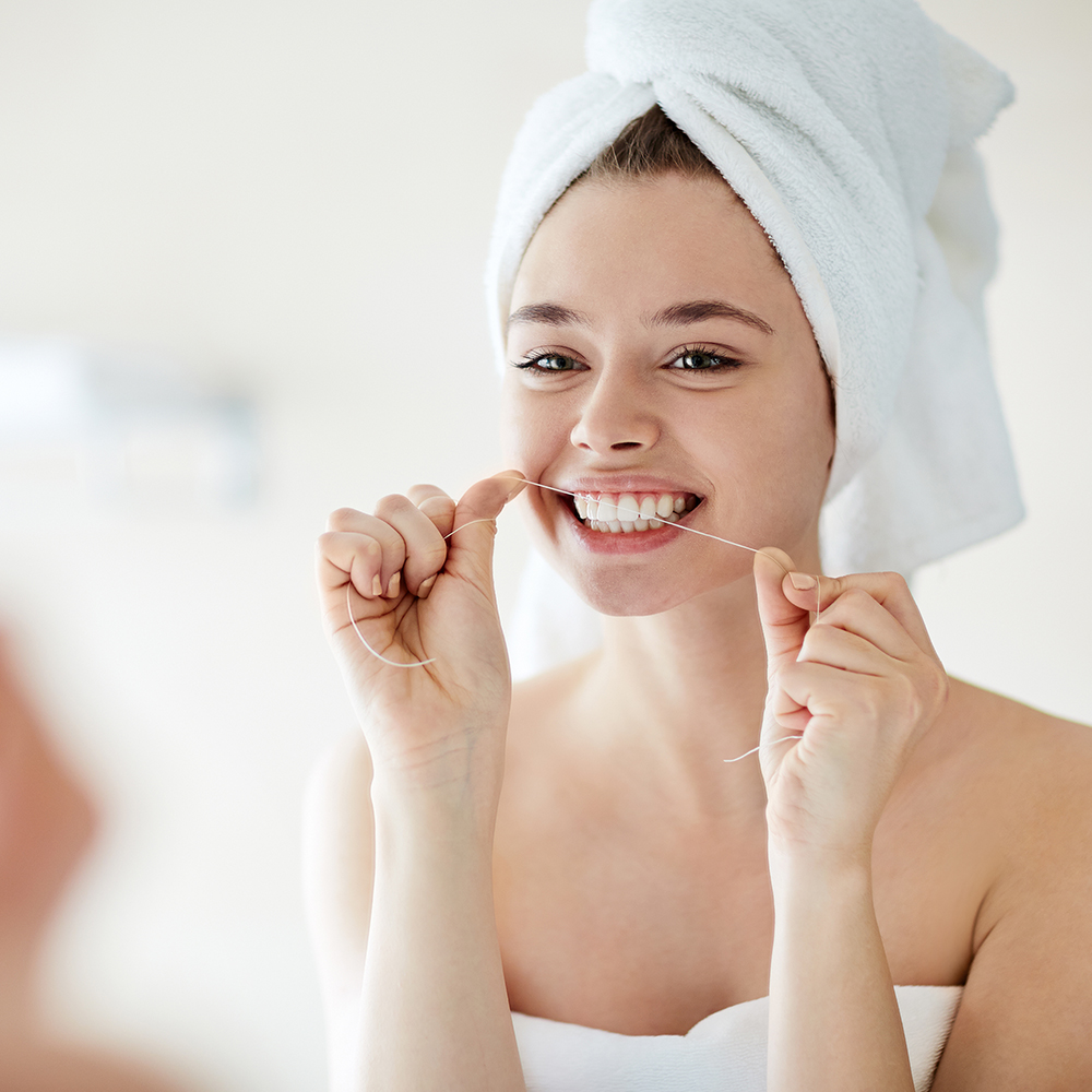 Oral hygiene essentials displayed on a white surface