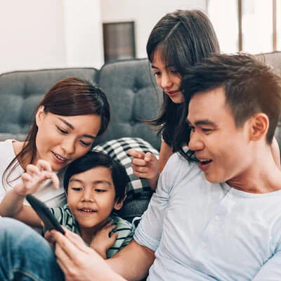 Happy family reviewing dental information on mobile phone