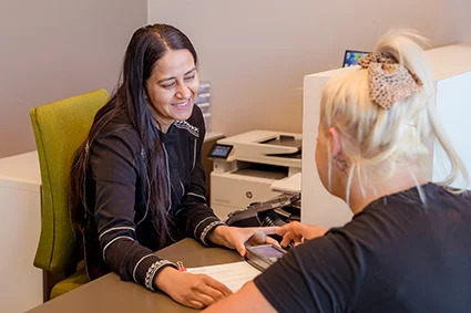 Friendly receptionist welcoming a patient at Officer Dental Care